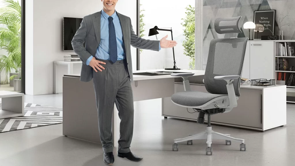 man in suit presenting ergonomic office chair