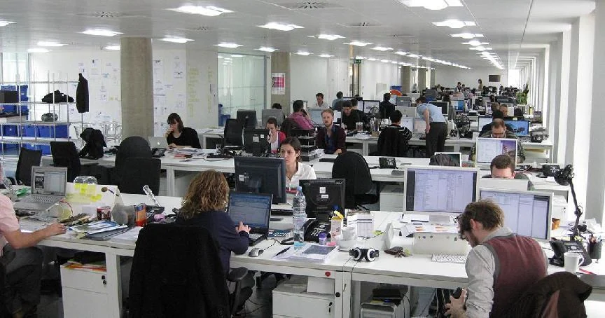 A person reclining comfortably on an ergonomic office chair with their body leaning back and fully supported by the backrest and headres